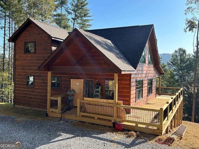 rear view of property with covered porch