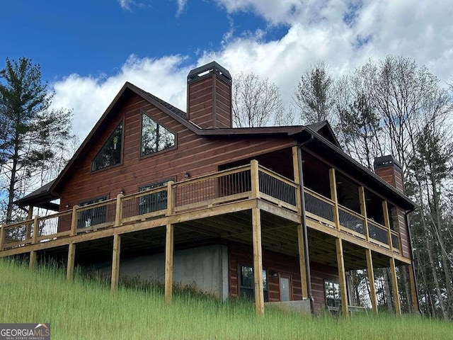 rear view of property featuring a deck