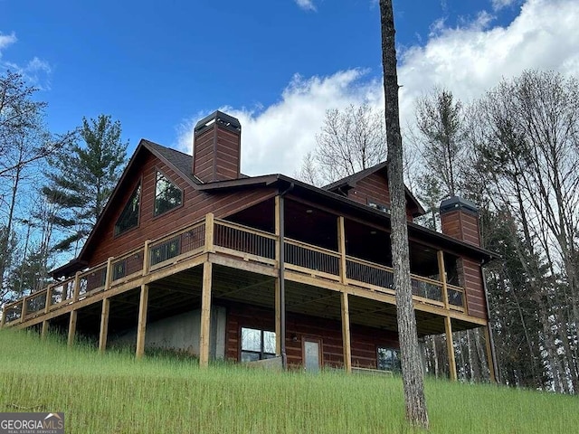 rear view of house with a wooden deck