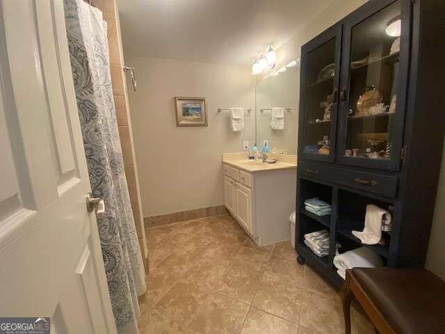 bathroom featuring vanity with extensive cabinet space and tile floors