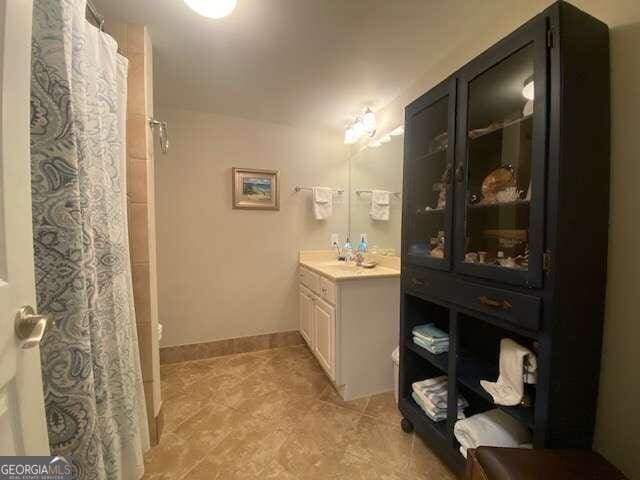 bathroom featuring tile flooring, oversized vanity, and toilet