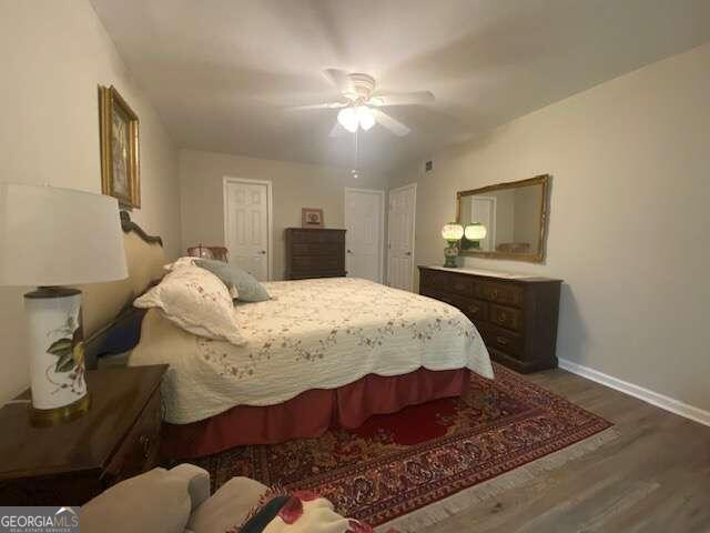 bedroom with hardwood / wood-style floors and ceiling fan