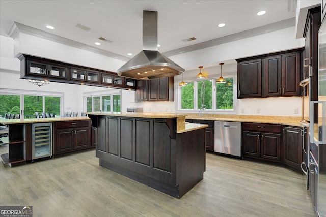 kitchen featuring decorative light fixtures, beverage cooler, dishwasher, island exhaust hood, and light wood-type flooring