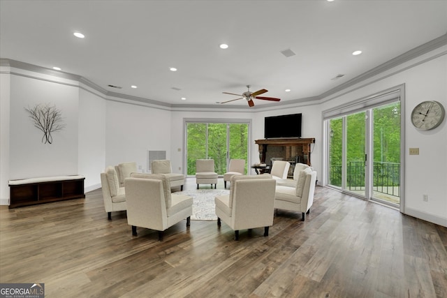 living room with crown molding, ceiling fan, and hardwood / wood-style floors