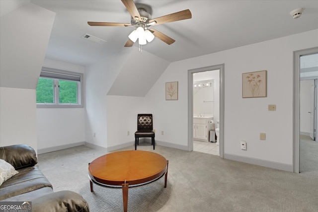 carpeted living room featuring ceiling fan and vaulted ceiling