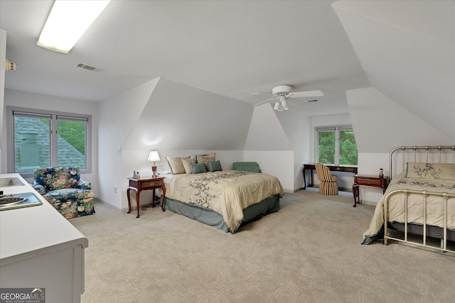 carpeted bedroom featuring ceiling fan and vaulted ceiling