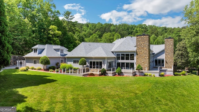 back of house featuring a sunroom and a yard