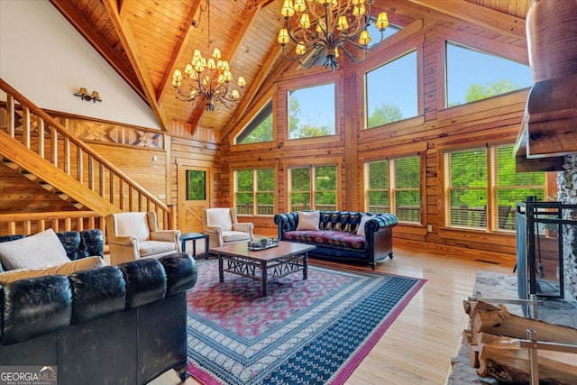 living room featuring a chandelier, high vaulted ceiling, wood-type flooring, and wooden ceiling