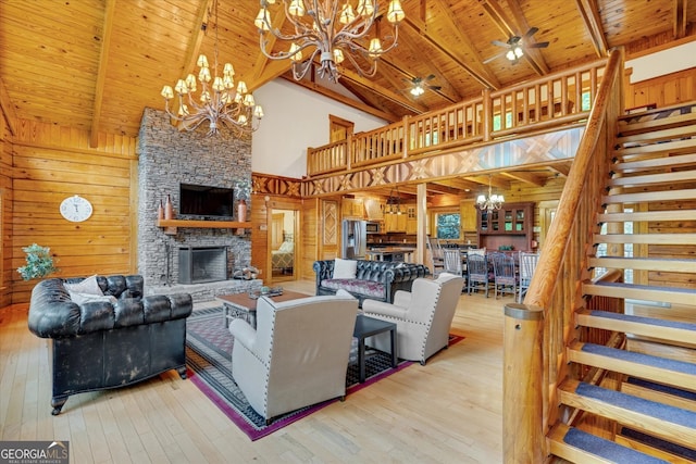 living room featuring wooden walls, wooden ceiling, a stone fireplace, and wood-type flooring