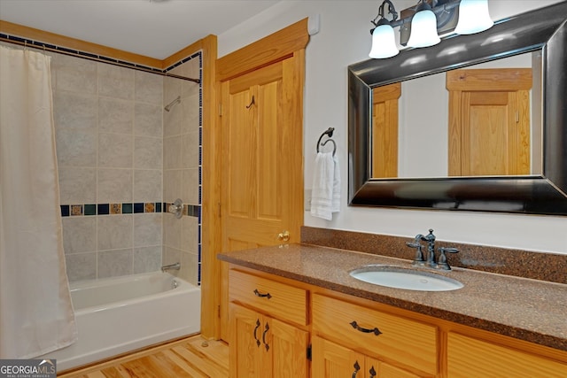 bathroom featuring shower / bath combination with curtain, hardwood / wood-style flooring, and vanity