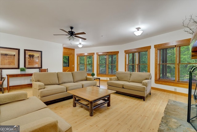 living room featuring ceiling fan and light wood-type flooring