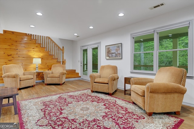 living room with wood walls and hardwood / wood-style floors