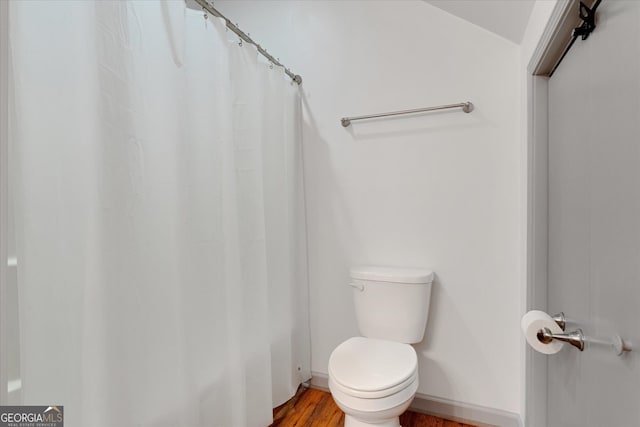 bathroom featuring hardwood / wood-style floors and toilet