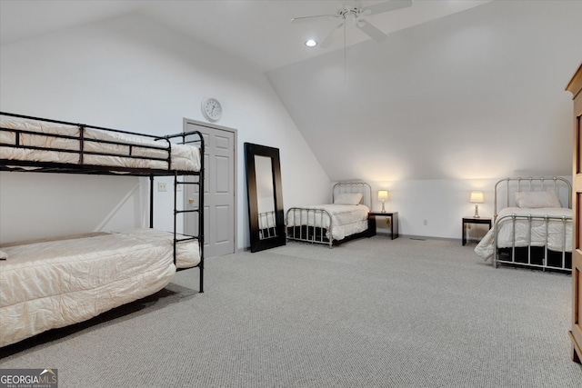 carpeted bedroom with ceiling fan and vaulted ceiling