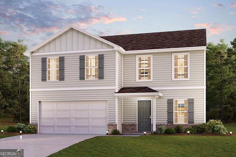 view of front facade with a yard and a garage