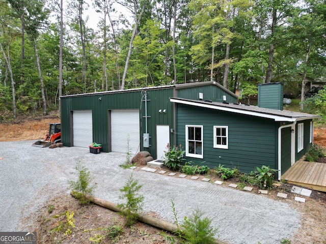 view of front of property featuring a garage and an outbuilding