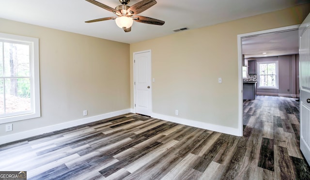 unfurnished room featuring ceiling fan and dark hardwood / wood-style floors