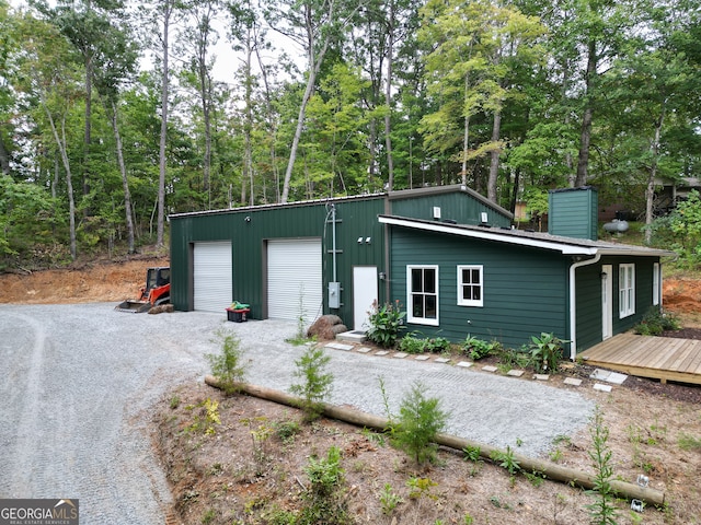 exterior space with a garage and an outdoor structure