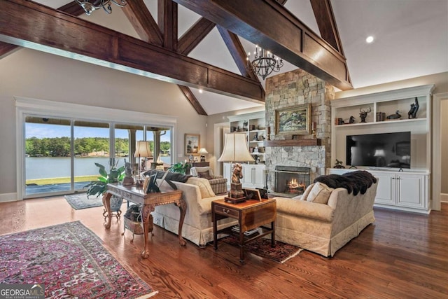 living room featuring a stone fireplace, a water view, high vaulted ceiling, dark hardwood / wood-style floors, and built in shelves