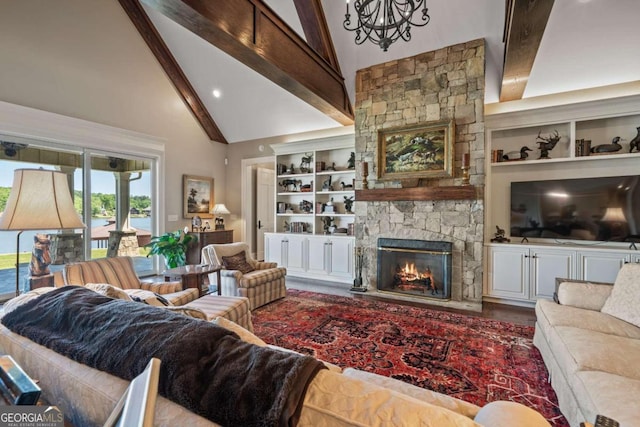 living room featuring a stone fireplace, beamed ceiling, high vaulted ceiling, an inviting chandelier, and built in features