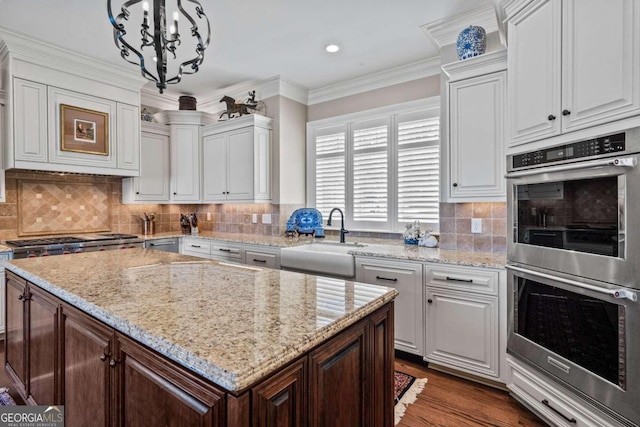 kitchen featuring sink, pendant lighting, white cabinets, and appliances with stainless steel finishes