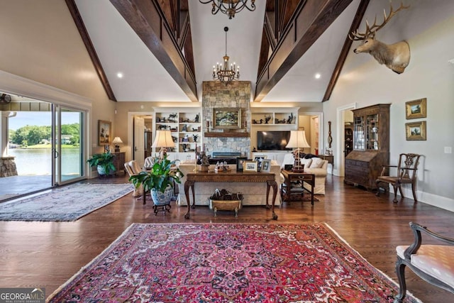 living room with a fireplace, high vaulted ceiling, built in features, and dark hardwood / wood-style flooring