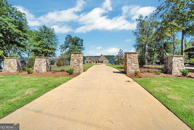 view of gate featuring a yard