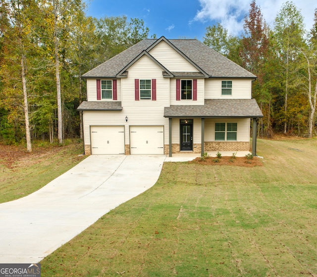 view of front of home featuring a garage and a front lawn