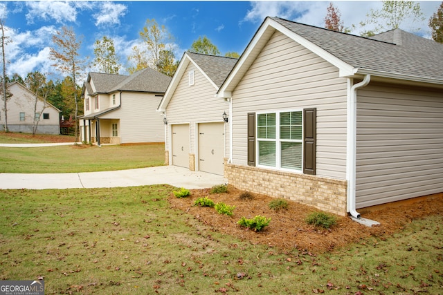 view of front of home with a front lawn and a garage