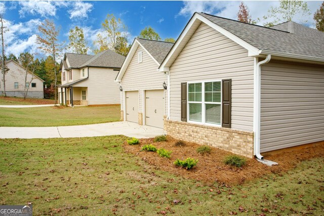 168 Chapman Ridge Rd, Macon, GA 31211 - view of side of property with roof with shingles, a lawn, and concrete driveway