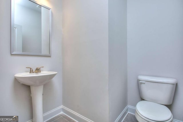 168 Chapman Ridge Rd, Macon, GA 31211 - half bathroom with toilet, baseboards, tile patterned floors, and a sink