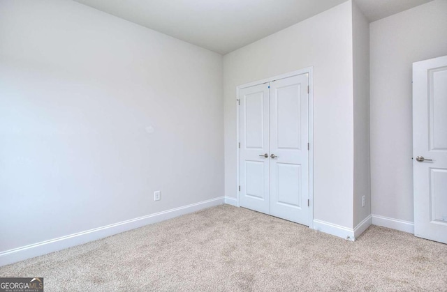 168 Chapman Ridge Rd, Macon, GA 31211 - unfurnished bedroom with carpet, baseboards, and a closet