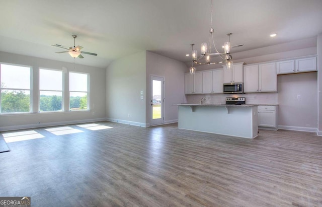 168 Chapman Ridge Rd, Macon, GA 31211 - kitchen featuring stainless steel appliances, open floor plan, baseboards, white cabinetry, and ceiling fan
