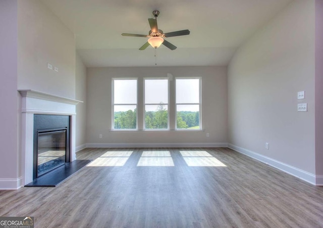 168 Chapman Ridge Rd, Macon, GA 31211 - unfurnished living room with a ceiling fan, baseboards, wood finished floors, and a glass covered fireplace