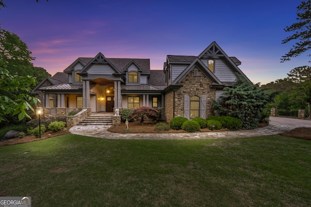 view of front of house featuring metal roof, a yard, and a standing seam roof