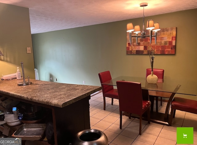 tiled dining room featuring a textured ceiling and a notable chandelier