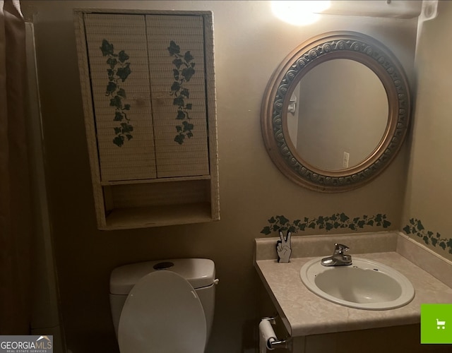 bathroom featuring toilet and vanity