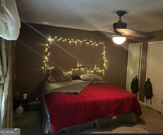 carpeted bedroom with ceiling fan