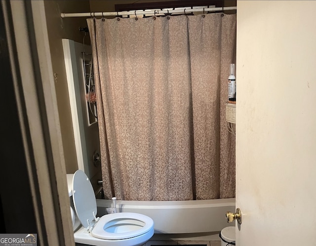 bathroom with shower / bath combination with curtain and toilet