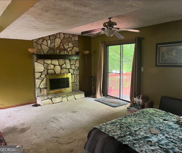 bedroom with carpet floors, a fireplace, access to outside, and a textured ceiling