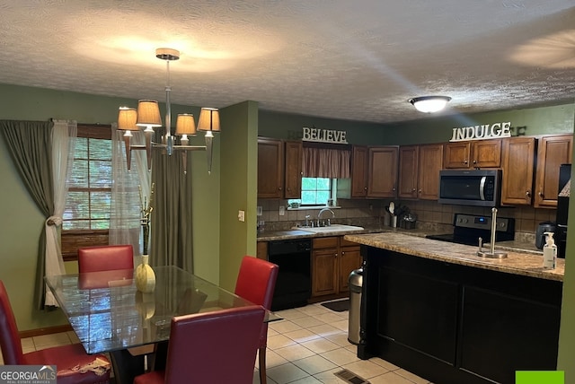 kitchen with dishwasher, tasteful backsplash, range, sink, and an inviting chandelier