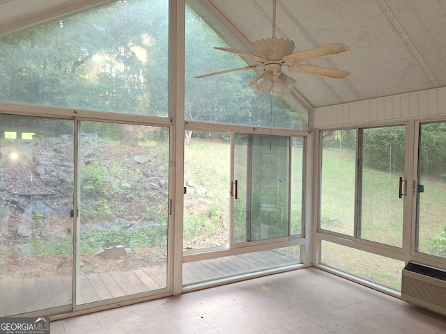 unfurnished sunroom with vaulted ceiling, an AC wall unit, and ceiling fan