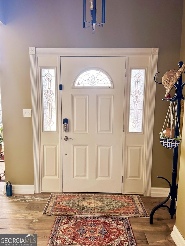 foyer entrance with plenty of natural light and hardwood / wood-style floors