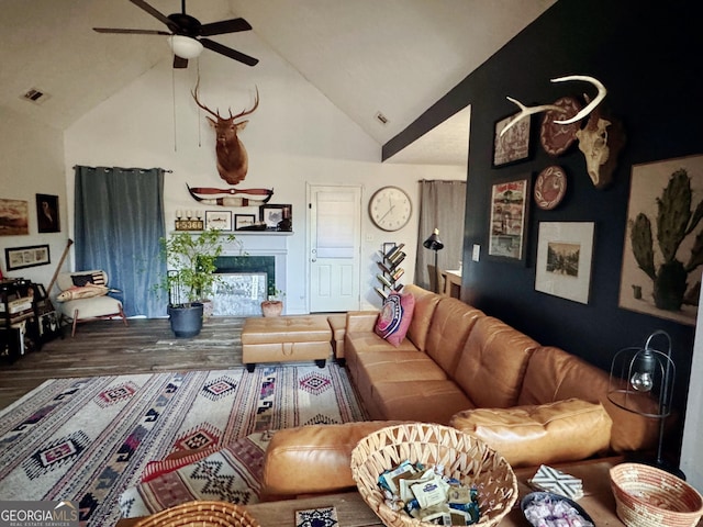 living room with ceiling fan and high vaulted ceiling