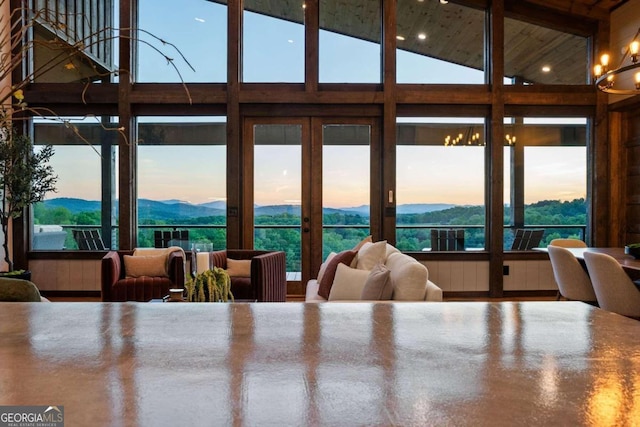 dining room featuring plenty of natural light, a mountain view, and an inviting chandelier