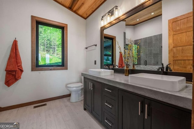 bathroom with dual bowl vanity, vaulted ceiling, toilet, hardwood / wood-style flooring, and wooden ceiling