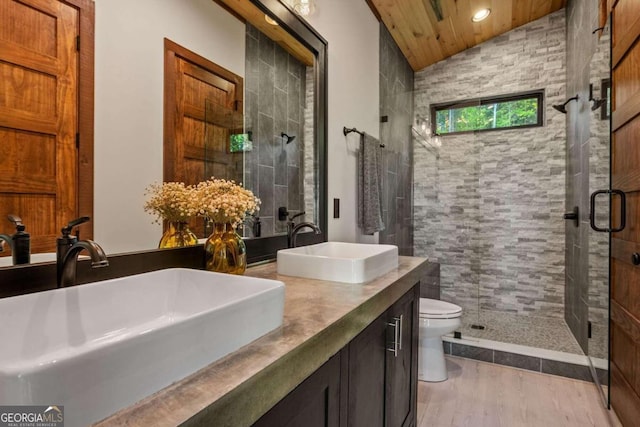 bathroom featuring double vanity, wood ceiling, lofted ceiling, an enclosed shower, and toilet