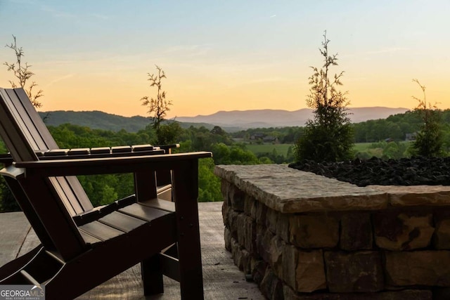 patio terrace at dusk featuring a mountain view