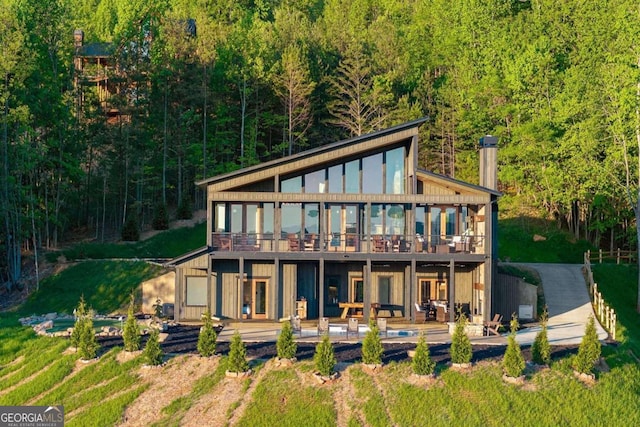 back of house featuring outdoor lounge area and a patio area