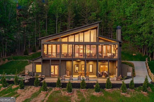 back of house featuring a patio and a balcony